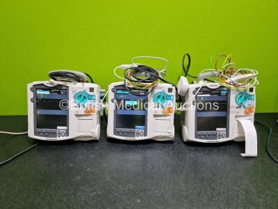 3 x Philips Heartstart MRx Defibrillators (Both Power Up) Including ECG and Printer Options with 1 x Philips M3725A Test Load, 2 x Philips M3539A Modules, 2 x M3538A l-ion Rechargeable Batteries, 2 x Paddle Leads and 2 x 3 Lead ECG Leads