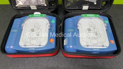 2 x Laerdal Heartstart HS1 Defibrillators with 2 x Lithium Batteries *Install Before 2024 / 2025* and 2 x Electrode Pads *Expire 2024 / 2025* in Carry Cases (Both Power Up) *SN A05A-02217 / A05A-02241* - 3