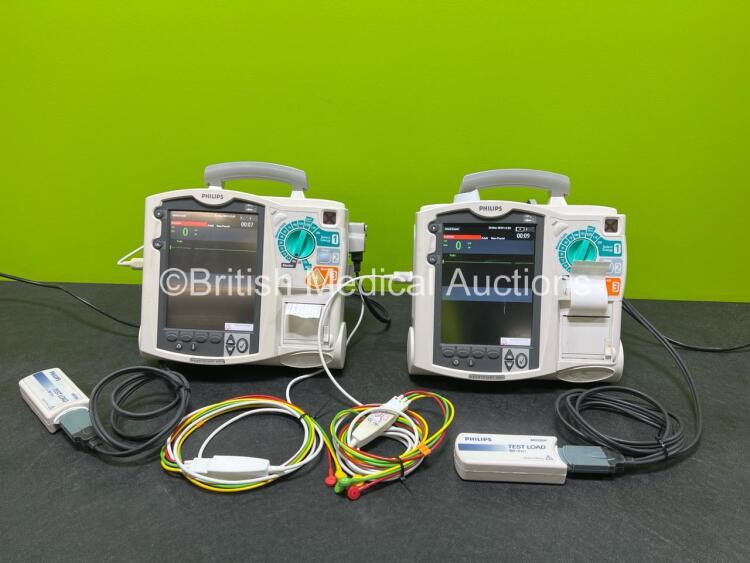 2 x Philips Heartstart MRx Defibrillators (Both Power Up, 1 x Scratched Screen - See Photos) Including ECG and Printer Options, 2 x Paddle Leads, 2 x Test Loads, 2 x 3 Lead ECG Leads, 2 x Philips M3539A Modules and 2 x Philips M3538A Li-Ion Batteries *SN