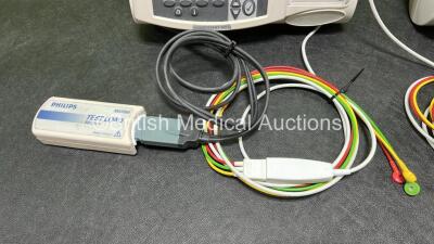 2 x Philips Heartstart MRx Defibrillators (Both Power Up, 1 x Scratched Screen - See Photos) Including ECG and Printer Options, 2 x Paddle Leads, 2 x Test Loads, 2 x 3 Lead ECG Leads, 2 x Philips M3539A Modules and 2 x Philips M3538A Li-Ion Batteries *SN - 5