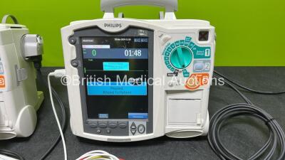 2 x Philips Heartstart MRx Defibrillators (Both Power Up, 1 x Scratched Screen - See Photos) Including ECG and Printer Options, 2 x Paddle Leads, 2 x Test Loads, 2 x 3 Lead ECG Leads, 2 x Philips M3539A Modules and 2 x Philips M3538A Li-Ion Batteries *SN - 2