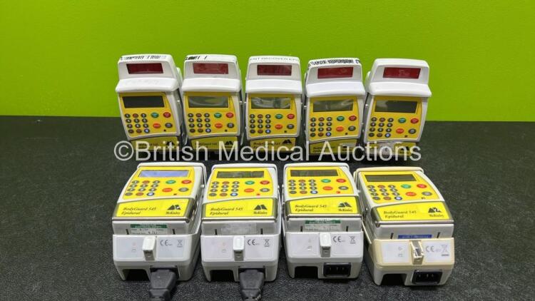 9 x McKinley 545 Bodyguard Epidural Infusion Pumps with 9 x Pump Chargers (8 x Power Up, 1 x No Power, 1 x Mark On Screen, 3 x Damaged Cases and 8 x Missing Batteries - See Photos)