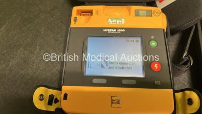 2 x Medtronic Lifepak 1000 Defibrillators (Both Power Up) in Carry Cases with 2 x Lithium Batteries *Install Before - 2025-07 / 2028-04* and 2 x Lead ECG Leads *SN 43820821 / 43820819* - 2