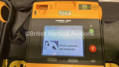 2 x Medtronic Lifepak 1000 Defibrillators (Both Power Up) in Carry Cases with 2 x Lithium Batteries *Install Before - 2025-07 / 2028-04* and 2 x Lead ECG Leads *SN 43820821 / 43820819* - 3