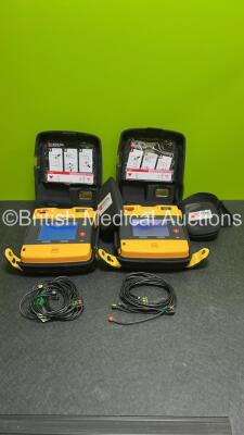 2 x Medtronic Lifepak 1000 Defibrillators (Both Power Up - 1 x Cracks to Display - See Photo) in Carry Cases with 2 x Lithium Batteries *Install Before - 2025-07 / 2028-04* and 2 x Lead ECG Leads *SN 45907118/ 43820822*