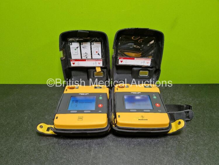 2 x Medtronic Lifepak 1000 Defibrillators *Mfd - 2013 / 2009* (Both Power Up) in Carry Case with 2 x Li/Mn02 Batteries *Install Before - 2024 / 2028*