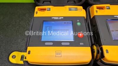 2 x Medtronic Lifepak 1000 Defibrillators *Mfd - 2013 / 2009* (Both Power Up) in Carry Case with 2 x Li/Mn02 Batteries *Install Before - 2024 / 2028* - 2